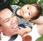 Having fun on top of daddy's shoulders (1 year)